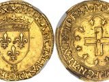 a gold coin with a cross on the front and a shield on the back