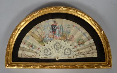 an old fan with a painting of a man and a woman on it