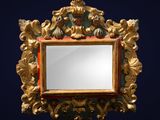 an ornate gold mirror with a blue background and a black background