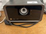 a small projector sitting on a table next to a phone