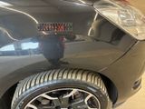 a close up of a tire on a car in a showroom