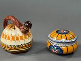 two small vases sitting next to each other on a table