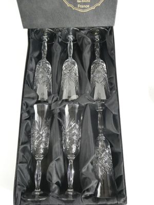 four wine glasses in a black box with a black ribbon