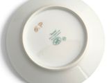 a white plate with a green and yellow design on it