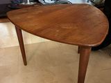 a small table with a wooden top on a tiled floor