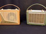 two old fashioned radio ' s sitting side by side on a black background