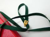 a green ribbon with a gold heart on it