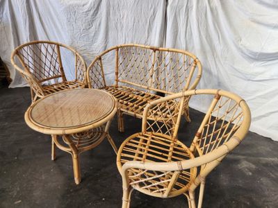 four chairs and a table that are sitting on the floor