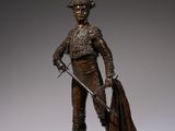 bronze statue of a bullfighter with a cape and a sword