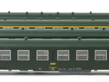 four green train cars sitting next to each other on a white surface