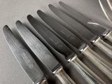 a lot of knives that are sitting on a table