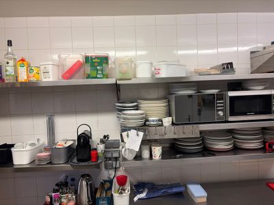 a kitchen with a lot of dishes on the counter