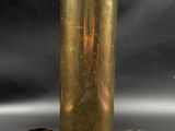 three brass vases sitting next to each other on a table