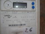 a white meter with a blue button on it
