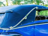 a close up of an old blue car with a black roof
