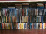 a book shelf full of dvd ' s in a room