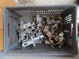 a basket full of assorted metal parts on the floor