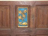 a wooden panel with a blue and gold design on it