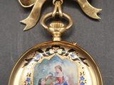 a gold pocket watch with a picture of a child on it