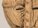 an image of a wooden mask with a face made out of wood