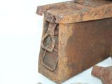 an old rusted iron box sitting on a white surface