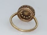 an image of a gold ring with a flower in the center