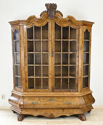 an old wooden cabinet with glass doors in a room