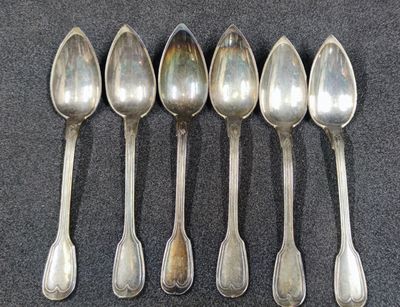 six spoons are lined up in a row on a table