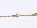 a close up of a gold chain with a clasp on a white background