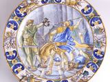 une assiette décorative ornée d'une peinture, accrochée au mur