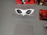 a box with a white mask and a red box with a black and white mask on it