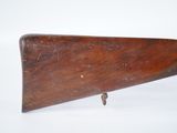 an old wooden rifle on a white surface with a white background