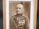 an old photo of a man in military uniform in a wooden frame
