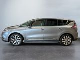 the silver car is parked in a large room with a white wall
