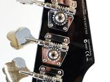 a close up picture of a guitar neck with a few knobs