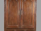 an old wooden armoire with two doors and two drawers
