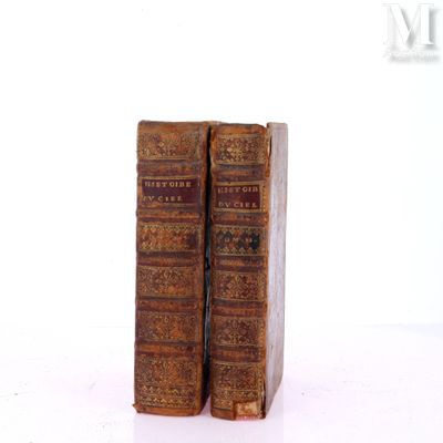 two old books that are sitting on a table