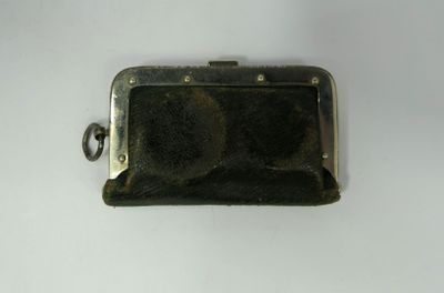 a black purse that is sitting on a white table