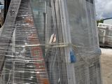 a forklift carrying a large load of glass