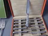 a bunch of knives and forks in a box