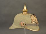 a green hat with a gold eagle on it