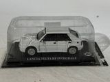 a white car in a glass case on a table