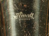a close up of a silver vase with a small logo on it