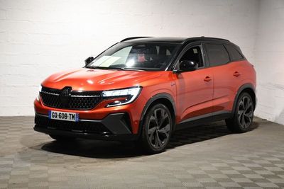 the orange suv is parked in a large room with checkered flooring