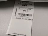 a label on the back of a white shirt