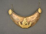 an image of a gold plated necklace with a lion and a bird on it