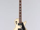 a close up of a white electric guitar on a white background