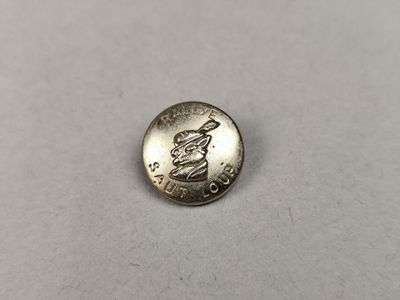 a silver coin with a statue on it sitting on a table