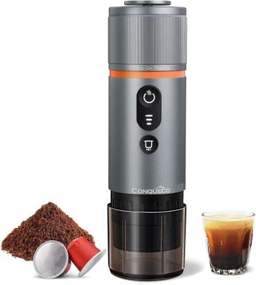a close up of a coffee grinder next to a cup of coffee