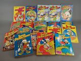 a bunch of cartoon books sitting on top of a table